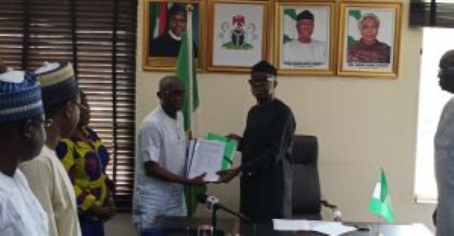 Minister of Industry, Trade and Investment, Otunba Adeniyi Adebayo receiving the draft legislation for the Nigeria Weights and Measures Regulatory Agency on Friday in Abuja.